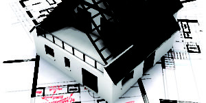 House mockup on top of blueprints with red pen notes and corrections