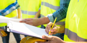 builders in a formal tendering process making notes on a clipboard